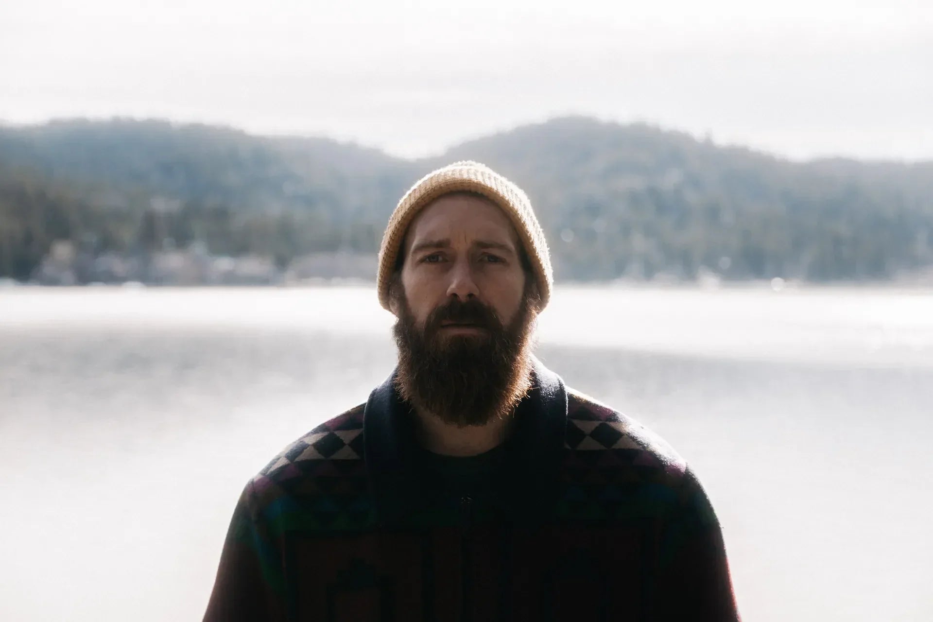 Confused bearded man by the lake