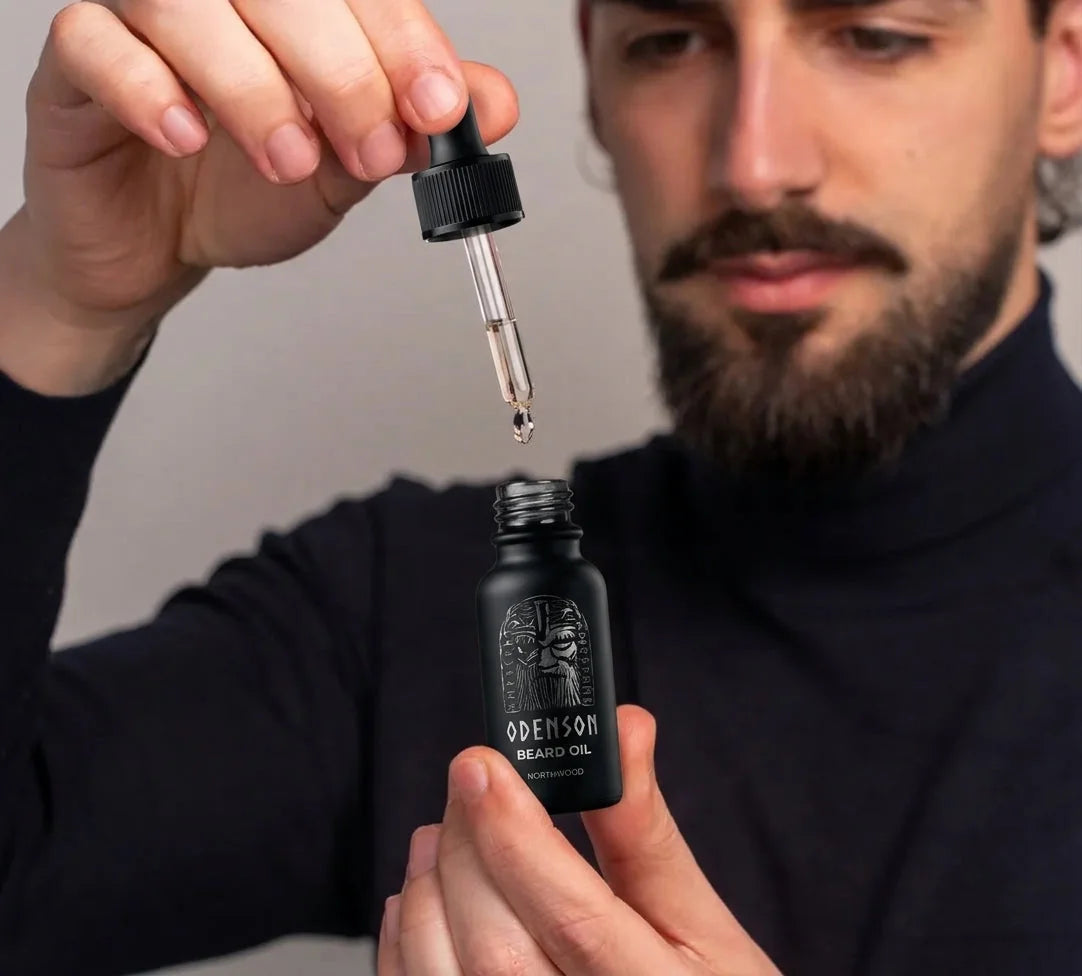 Man applying Odenson Beard Oil to his beard